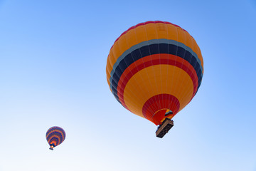 Flying hot air balloons in the sky in Goreme, Cappadocia, Turkey