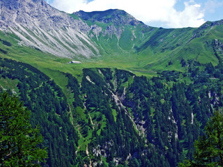 Grassy alpine valley Höttatal (Hottatal or Hoettatal) below the peak of Augstenberg and in the...