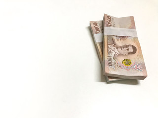Stacked of cash 1000 baht banknote Thai isolated on white background. Savings and investing concept Pile of cash bills amount million.