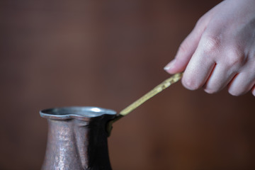 Brewing traditional turkish coffee in copper cezve