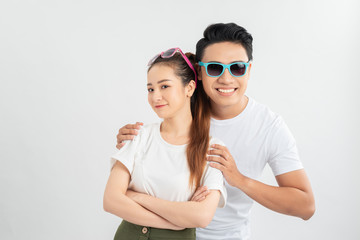 Surprised young couple looking at camera. Front view of excited young man and woman standing together and looking at camera on white background. Emotion concept