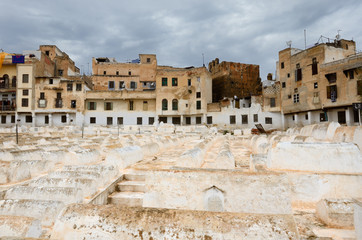 Fototapeta premium Rows of white tombs in the Mellah Jewish cemetery on a cloudy day in Fes Morocco