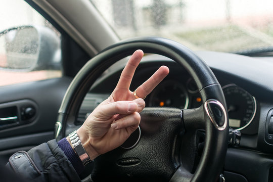 Man's hands on a steering wheel