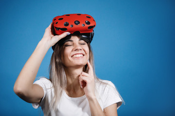 Young woman plays with virtual reality glasses