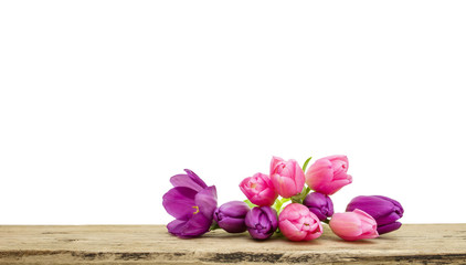 Pink and purple Tulip bouquet with green leaves isolated on white background