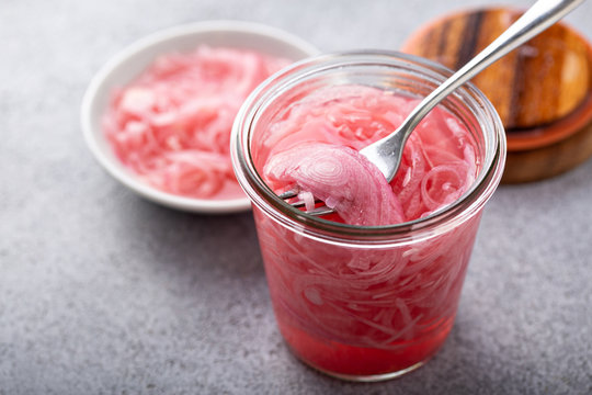 Marinated or pickled red onion in small jar for burgers or salads