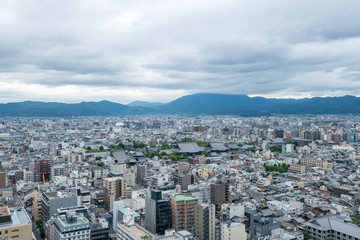 Fototapeta na wymiar Aerial view of the Kyoto cityscapes during the twilight in a cloudy day, Japan