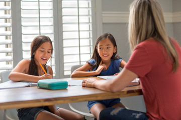 Mother Helping Her Daughters With Their Homework