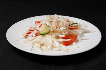 Plate with salad on the table.
