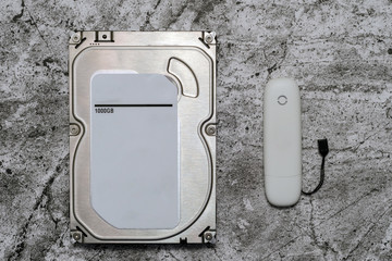 hard drive for computer and usb modem on an abstract background