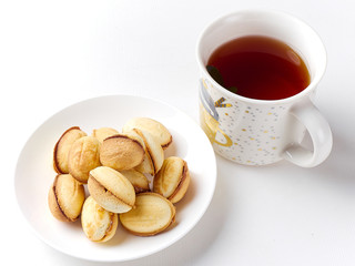 delicious walnut shaped shortbread sandwich cookies filled with sweet condensed milk and a mug of tea