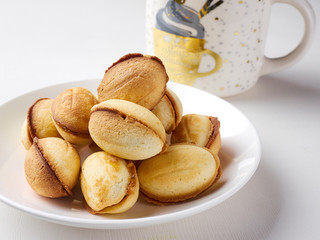 delicious walnut shaped shortbread sandwich cookies filled with sweet condensed milk and a mug of tea