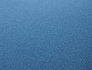 Polished surface of natural blue granite with white specks of a fine fraction.