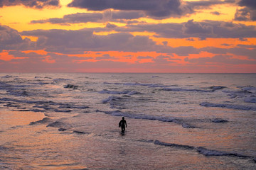 夕方の海とサーファー