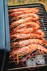 chef cooking grilled shrimps with sauce