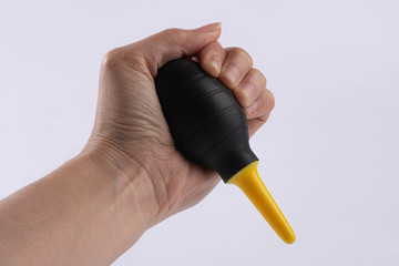rubber air blower in hand Oliver White background, accessory for dust removing