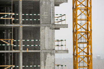 construction of a multi-storey residential building at winter time.