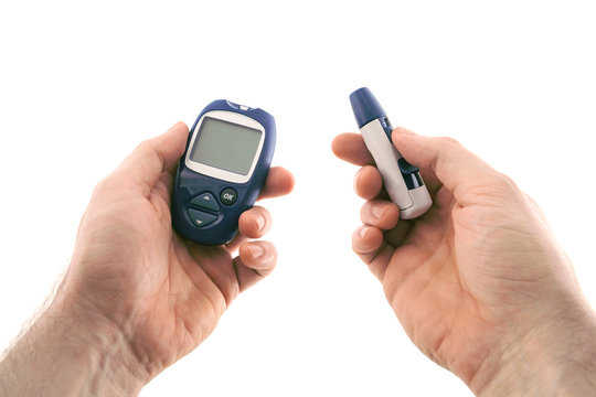 Glucometer and the lancing device in hands, isolated on white background