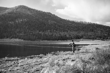 Fototapeta na wymiar Fly-fisherman at the lake