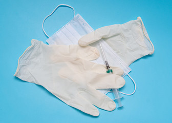 syringe mask gloves on blue background