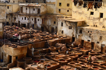 Vegetable tanning soaking vats with bark tanins and pigments at Fes Tannery Morocco