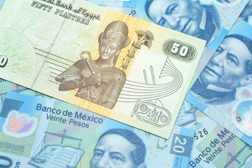 A close up image of an Egyptian fifty pisatres note with Mexican twenty peso bank notes in macro