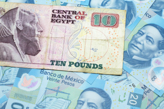 A close up image of an Egyptian ten pound bank note with Mexican twenty peso bank notes in macro