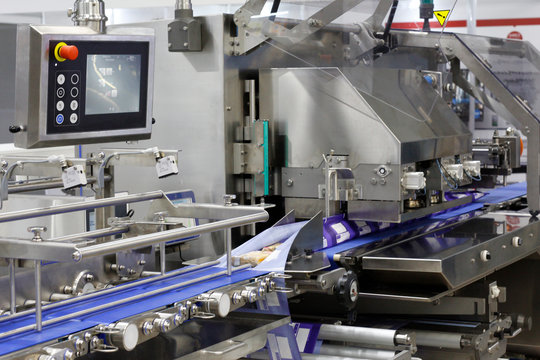 A Fragment Of The Packaging System. Automatic Conveyor For Food Packaging. Conveyor Belt At A Food Factory.