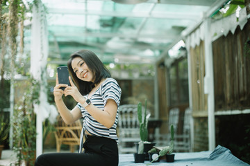 young woman using smart phone in the street
