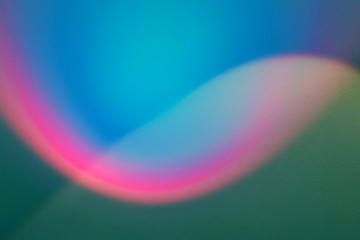 rainbow light beam on plaster wall. multicolored abstract design background