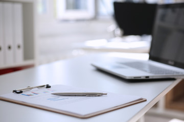 Financial statistics documents on clipboard pad at office table closeup. Internal Revenue Service inspector sum check, irs investigation, exchange market, earnings, savings, loan and credit concept