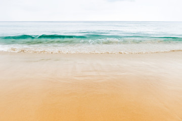 Beautiful smooth sand beach and green sea water, relaxing by the beach, outdoor cloudy day light