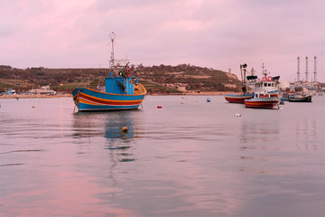 Fototapeta premium scenic view of traditional boats 'luzzu' at the harbour in Marsaxlokk