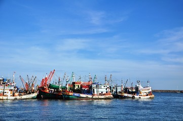 View of Thai fishing port on a clear bright day.	