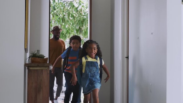 Parents And Children Opening Front Door And Returning Home Together