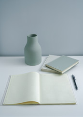 Naklejka premium Minimalist book notebook and a plain vase 