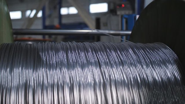 Aluminum wire pulley rolling. Winding the aluminum cable onto the reel.