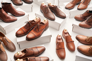 Elegant brown male shoes on boxes