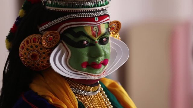 Close up of a Kathakali dancer smiling. 