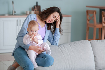 Young woman suffering from postnatal depression at home