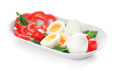 Fresh boiled eggs with vegetables on white background