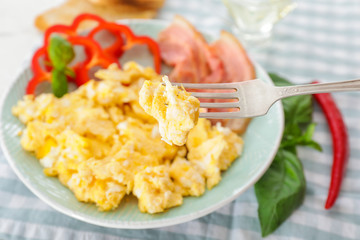Eating of scrambled egg from plate, closeup