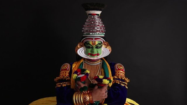 Kathakali dancer performing in his costume. 