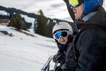 Fototapeta na wymiar Family, skiing in winter ski resort on a sunny day, enjoying landscape