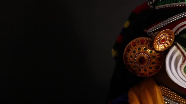 Close up of a Kathakali dancer giving an expression with his eyes. 