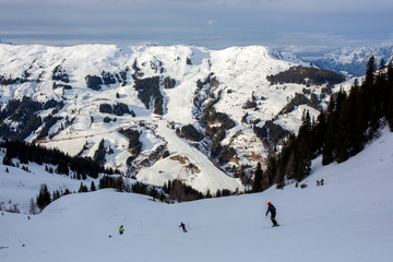Fototapeta na wymiar Family, skiing in winter ski resort on a sunny day, enjoying landscape
