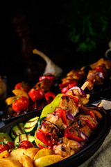 Shish kebab with various vegetables and spice country potatoes