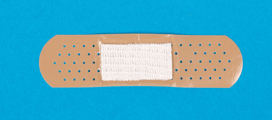 Band-aid against a blue background