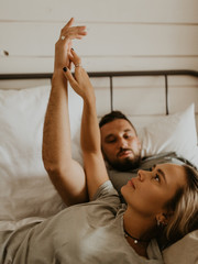 Beautiful loving couple kissing in bed