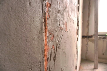 wall reinforcing mesh in plaster © taraskobryn